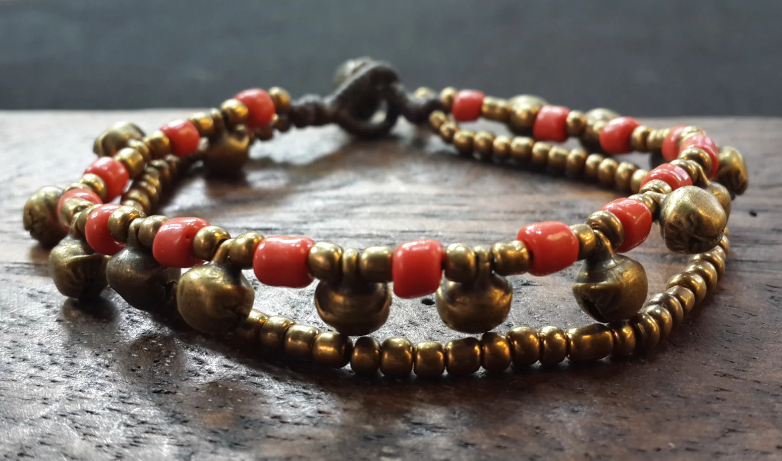 181-Brass-Bell-And-Red-Bead-Double-Strand-Bracelets-4.webp Brass Bell And Red Bead Double Strand Bracelets